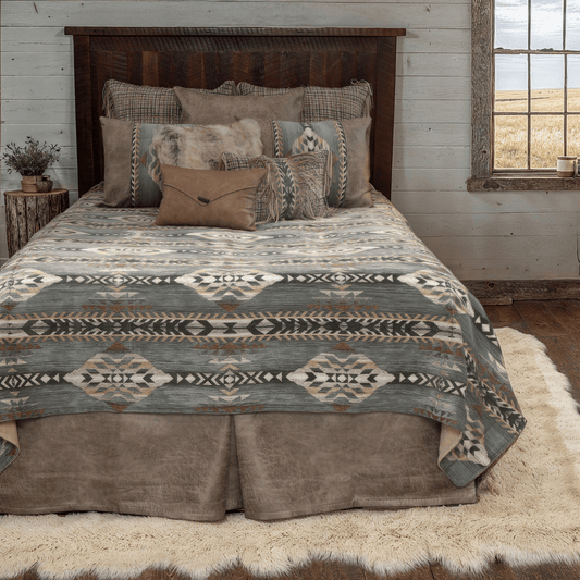 Bed with patterned bedding and pillows in a rustic bedroom setting.